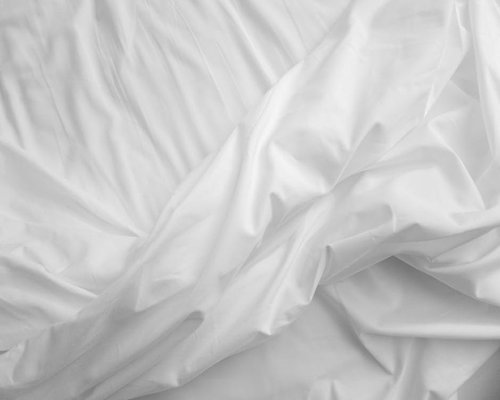 Quiet clean sleeping room interior featuring soft natural organic bedding material reflecting absolute rest